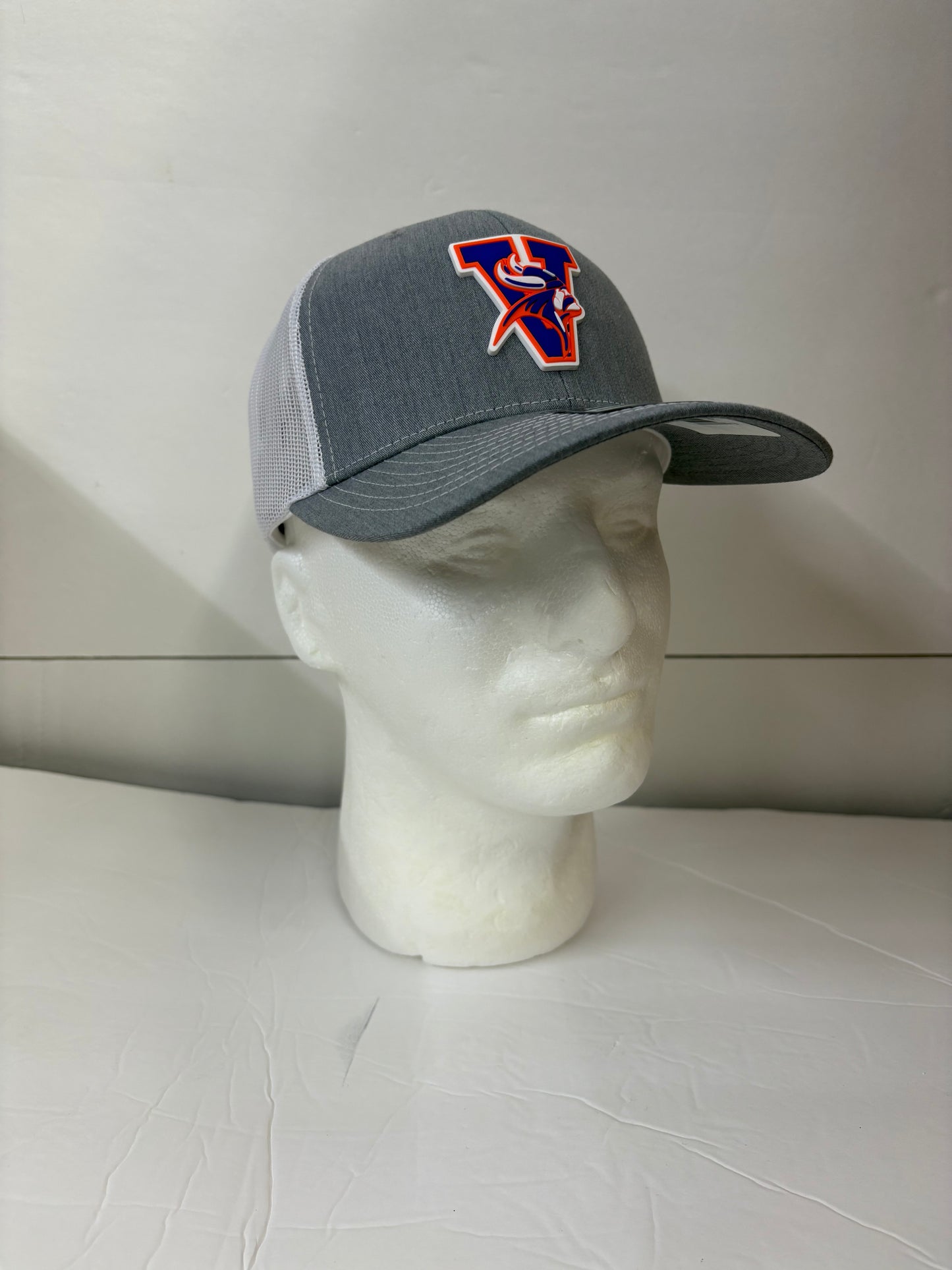 Gray Missouri valley college cap with a logo on a mannequin head against a white background